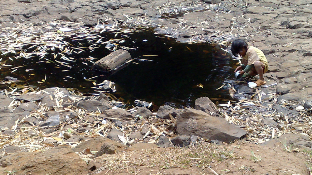 Boy drinking from contaminated water